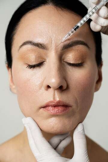 front-view-hand-injecting-woman-s-face_23-2149349933