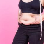 overweight-squeeze-belly-fat-with-measure-tape-her-neck_1150-34777