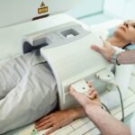 unrecognizable-radiologist-preparing-female-patient-abdomen-mri-scan-procedure-hospital_637285-423