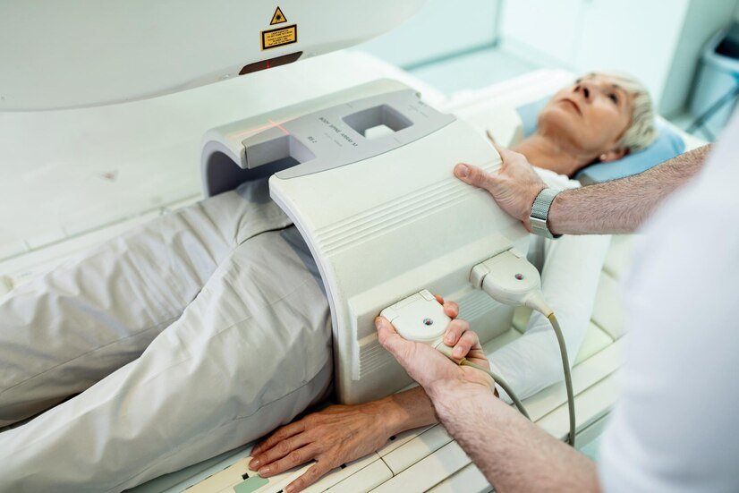 unrecognizable-radiologist-preparing-female-patient-abdomen-mri-scan-procedure-hospital_637285-423